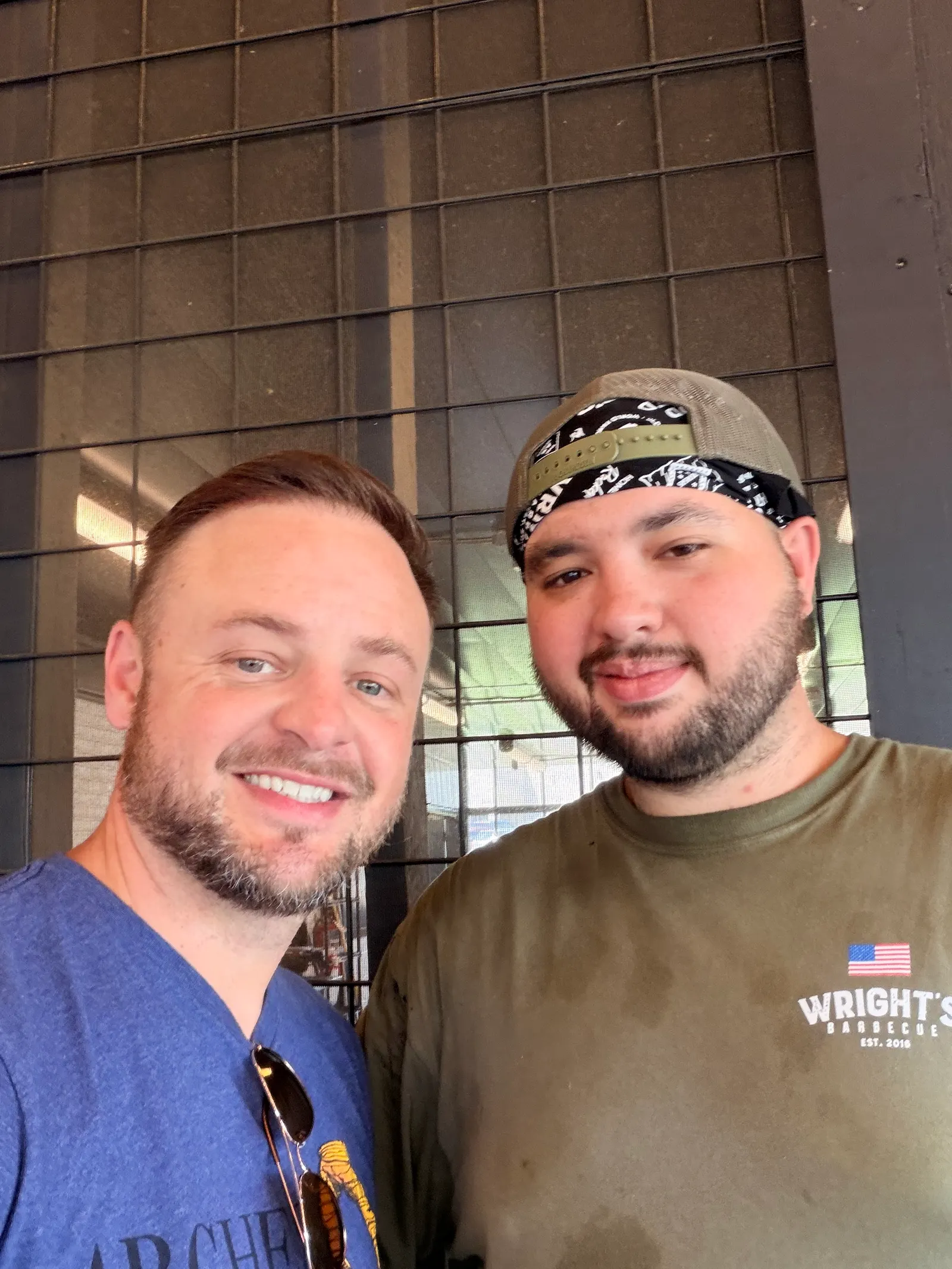 Brison McPhail and Wright's Barbecue pit crew member James Roach smiling in the pit room at the Benton location