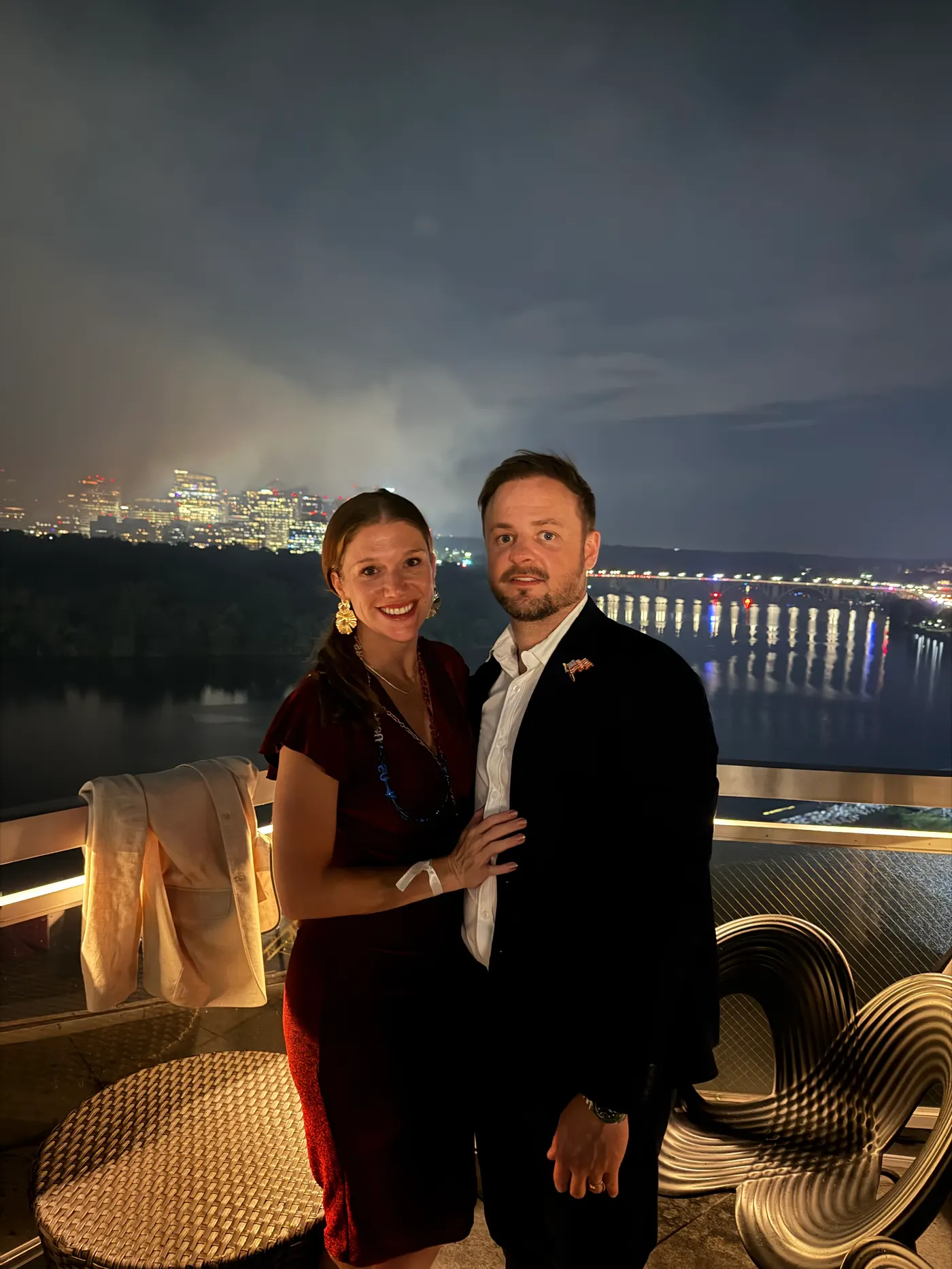 Brison McPhail and his wife on a rooftop overlooking the Potomac River at dusk in Washington, D.C.