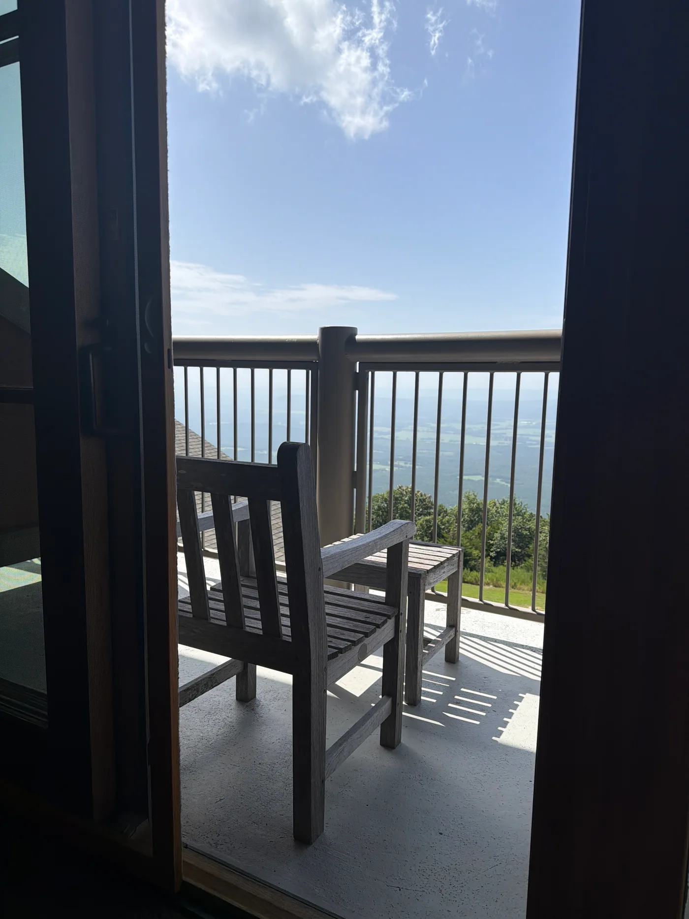 A chair on the balcony at the Lodge at Mount Magazine, looking out over the Arkansas River Valley from the top of the state