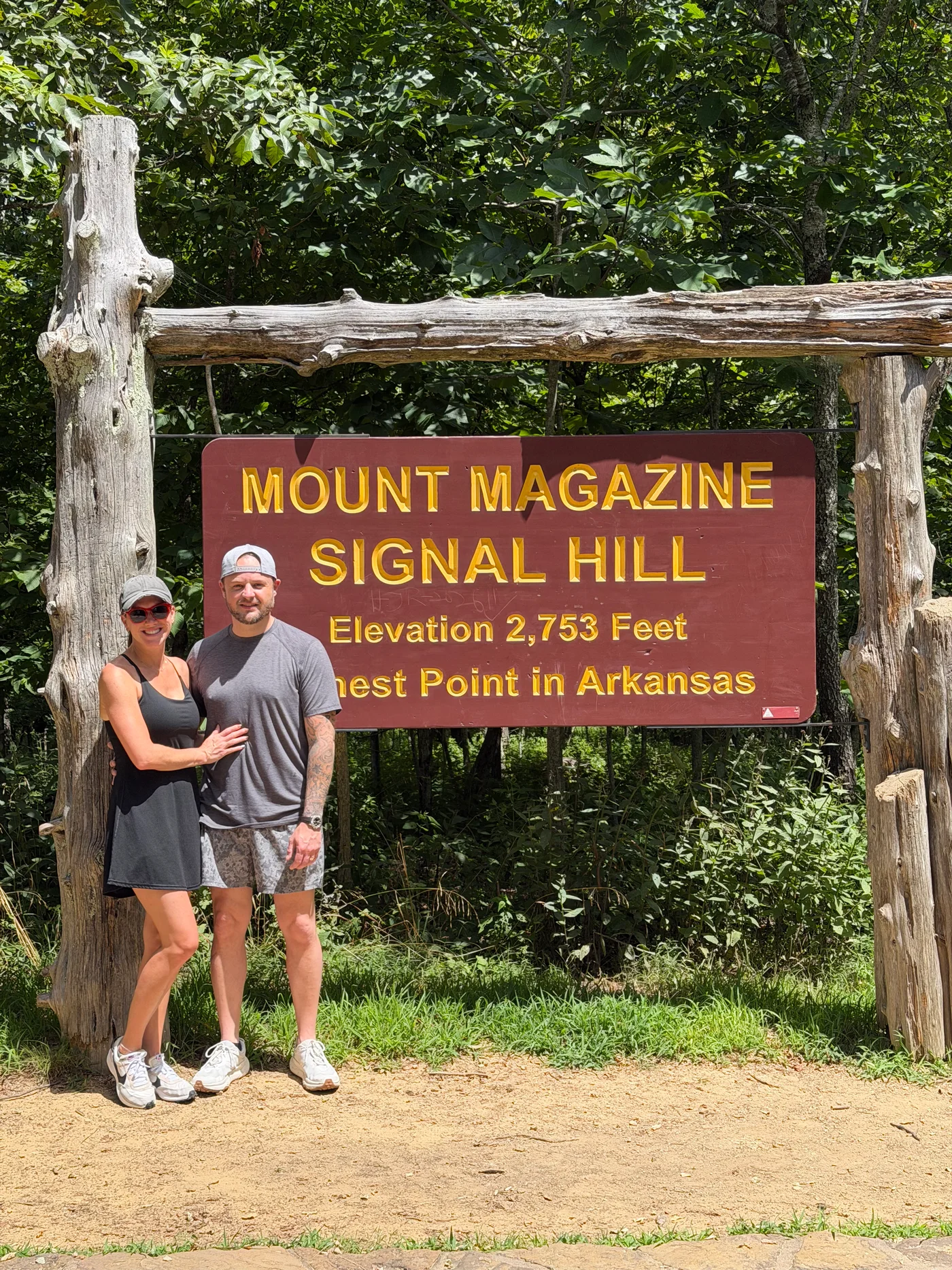 Brison McPhail of Jet Heat and Air and his wife at the Mount Magazine Signal Hill marker — Elevation 2,753 Feet, Highest Point in Arkansas