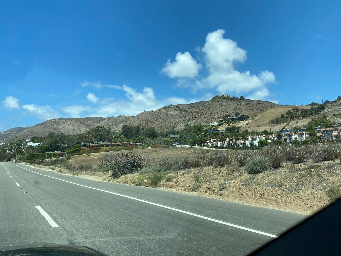A dry, sun-baked Southern California valley seen from the road on the drive up toward the mountains