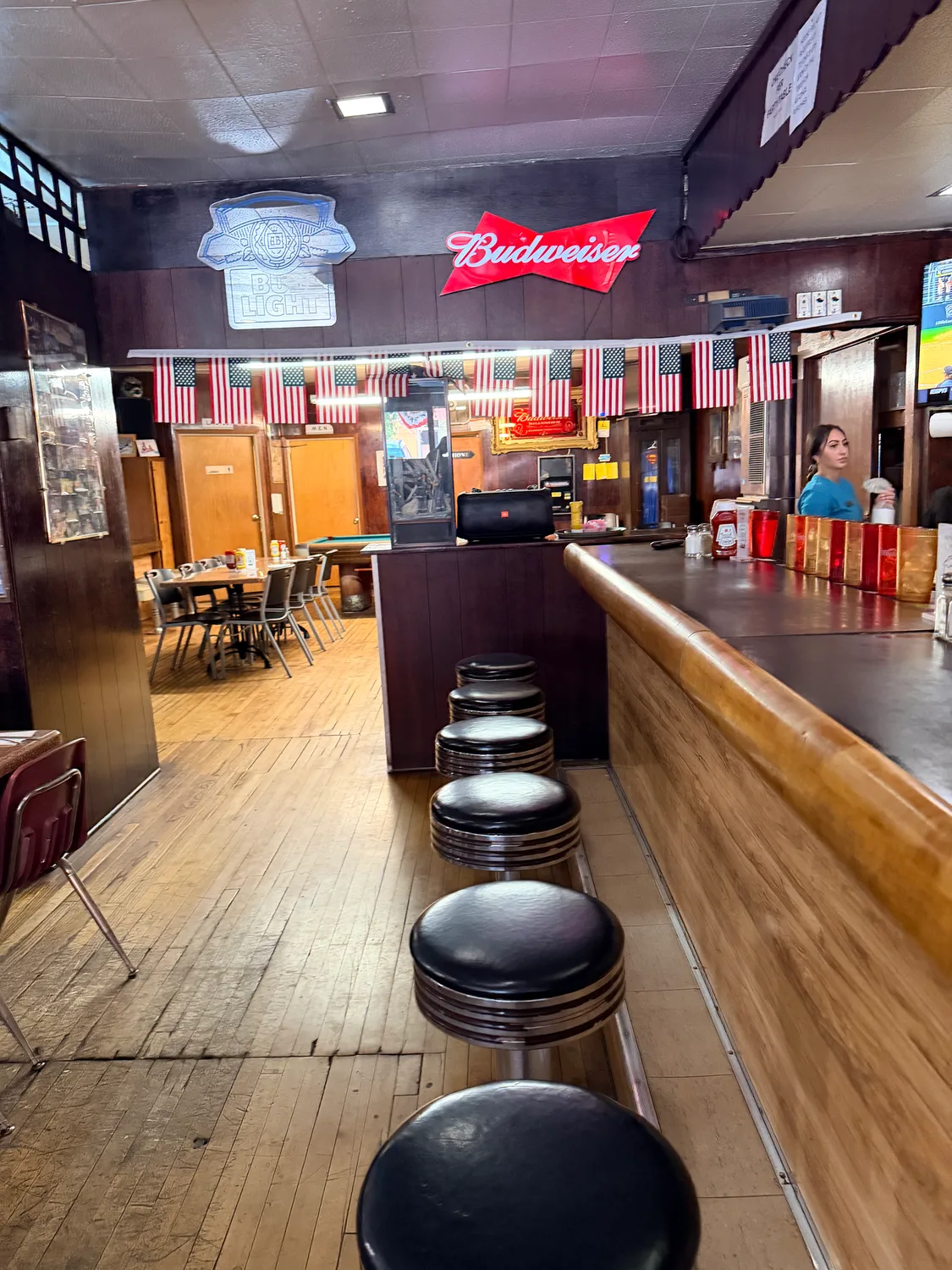Interior of Ray's Tavern with bar stools and American flags