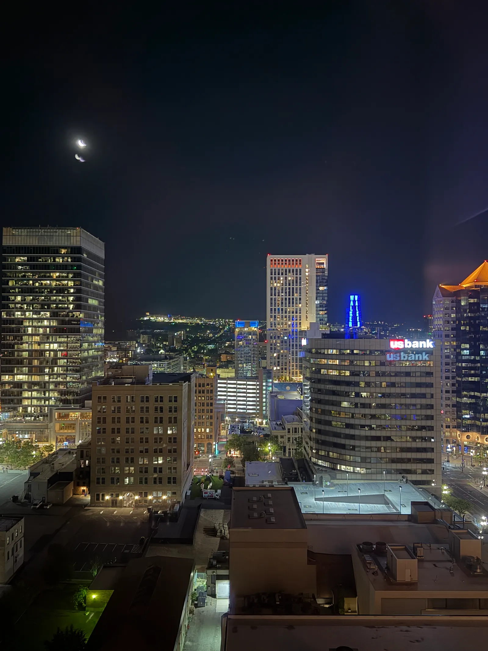 Downtown Salt Lake City at night from a high hotel floor, moon over the skyline
