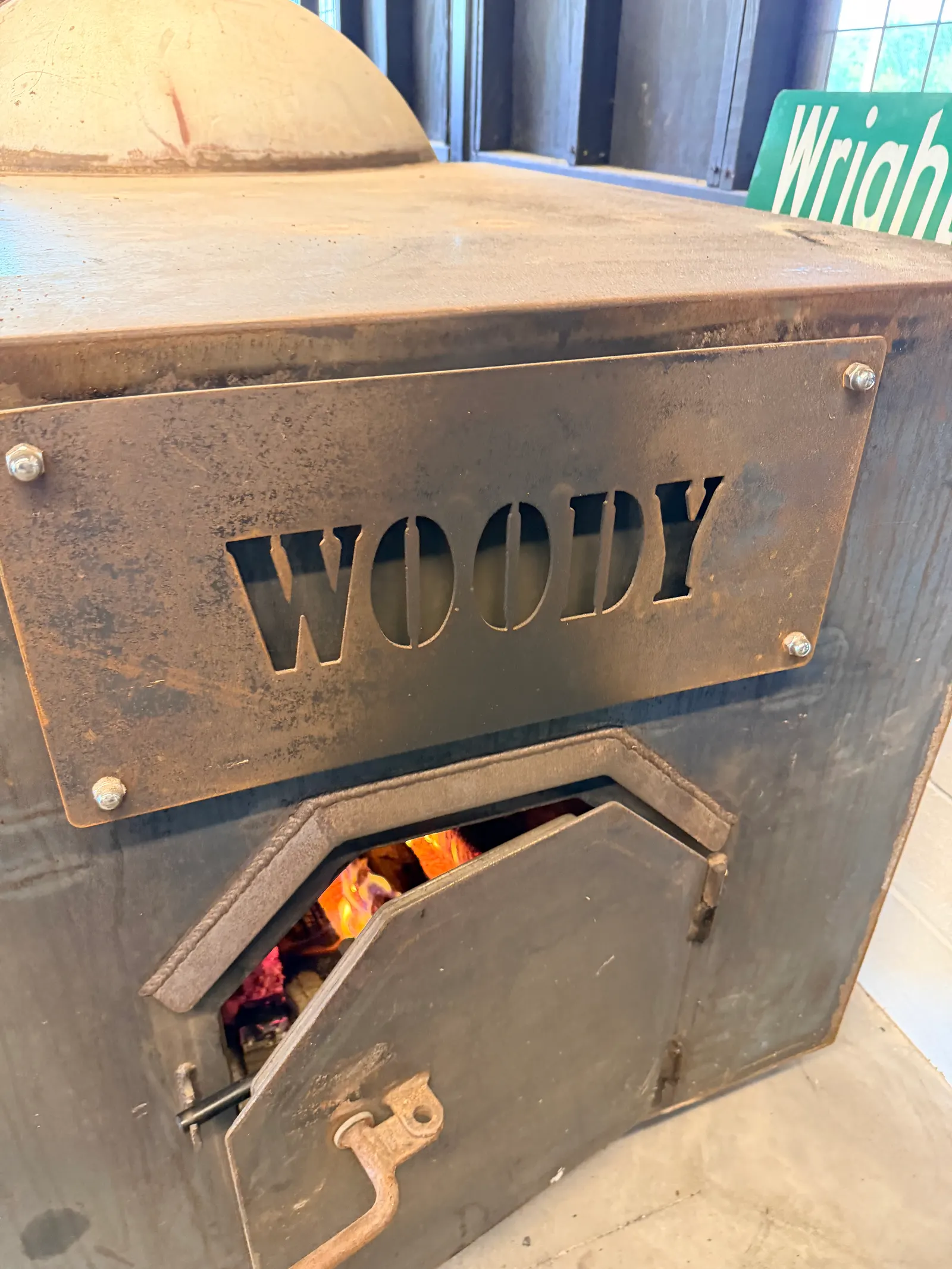 A Wright's Barbecue smoker firebox with the name Woody painted on it