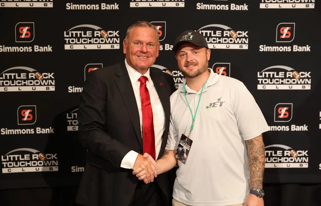 Brison McPhail of Jet Heat and Air shaking hands with Arkansas head coach Sam Pittman at the Little Rock Touchdown Club season opener