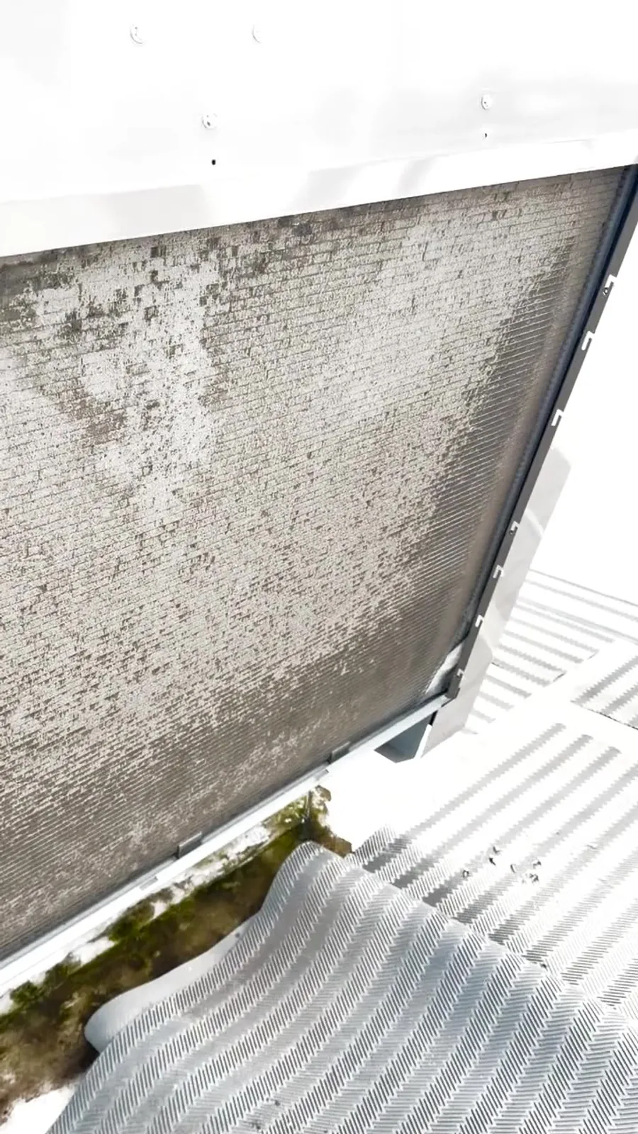 Close-up of a dirty rooftop AC coil before cleaning at Gassy's in Bryant, AR